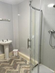 a bathroom with a shower and a sink at Adina Hotel in Blackpool