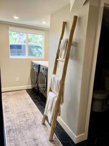a towel ladder in a laundry room with a washing machine at NEW Modern apt w/pool & hot tub in nature in Thousand Oaks