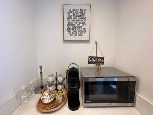 a kitchen counter with a microwave and a plate of food at Stunning View Hollywood Hills Guest House in Los Angeles