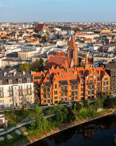 an aerial view of a city with orange buildings at Loft industrialny przy Bulwarze Staromiejskim in Wrocław