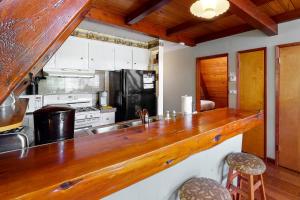 a kitchen with a large wooden counter top at Alford Family Lodge in Bass Lake