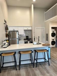 a kitchen with a large counter with two stools at Home Haven, Walk to Little Italy & Wooster Square in New Haven