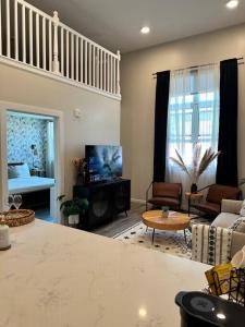 a living room with a couch and a tv at Home Haven, Walk to Little Italy & Wooster Square in New Haven