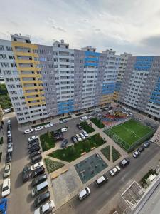 uma vista aérea de um parque de estacionamento com edifícios altos em DeLuxe Apartments em Almaty
