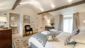 a bedroom with a large bed and a bathroom at Griffedale in Brassington