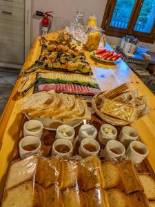 a table topped with different types of bread and dips at Rifugio Aleve in Castello
