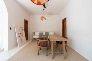 a dining room with a wooden table and chairs at Anat Tantric Boutique Hotel in Tulum