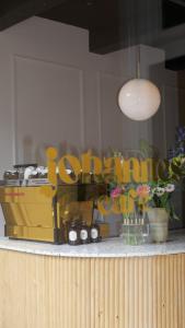 a sign for a store with flowers on a counter at Boutique Hotel Johannes in Delft