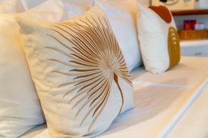 three pillows are sitting on a bed at Solarium de Gostoso in São Miguel do Gostoso