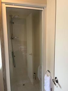 a shower with a glass door in a bathroom at Haggerston castle caravan rental. Annie's den in Beal +14 photos