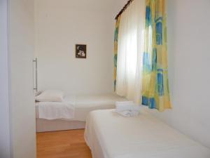 Postel nebo postele na pokoji v ubytování Apartments Nedjeljka