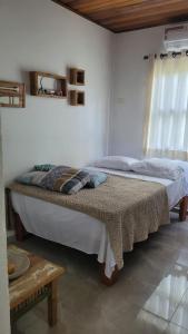 a bedroom with two beds and a table at Apto Duplex com Mezanino in Juquei