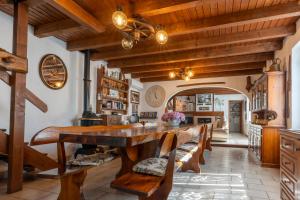 a large dining room with a wooden table and chairs at Villa Rosch in Lezzeno