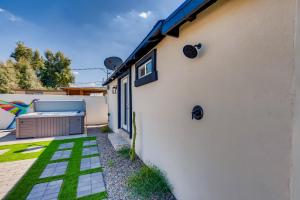 a backyard with a white building and a patio at The Urban Cowboy Bunk House in Phoenix