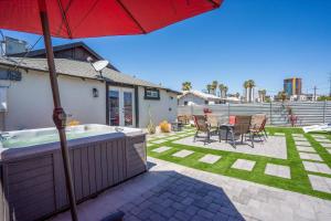a backyard with a hot tub and an umbrella at The Urban Cowboy Bunk House in Phoenix