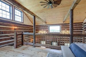 een kamer met houten wanden en een plafond met een ventilator bij Bedford Cabin with Porch, 5 Mi to Historic District! in Bedford