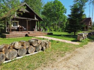 a pile of logs in front of a house at Ainja Puhkemaja in Viljandi