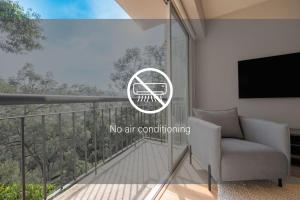 a living room with a no air conditioning sign on a balcony at Capitalia - Apartments - Santa Fe in Mexico City