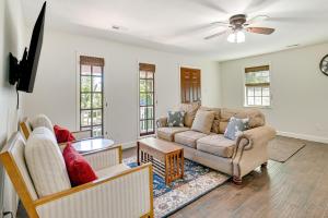 a living room with a couch and a table at Charming Apartment in Downtown Georgetown! in Georgetown