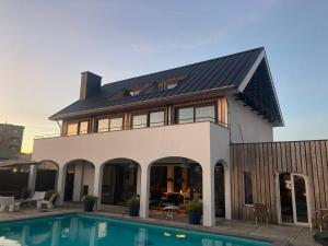 a house with a swimming pool in front of it at Villa Zandvoort in Zandvoort