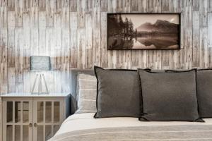 a bedroom with a bed with a wooden wall at Escape in Elegance in Scottsdale