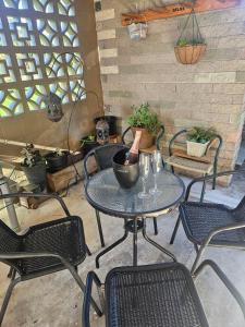 a table and chairs with wine glasses on a patio at Di's B&B in Matamata