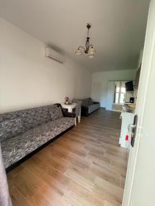 a living room with a couch and a wooden floor at Apartman K2 in Kraljevo
