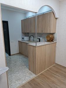 a kitchen with wooden cabinets and a sink at Tevosyan EVN Airport in Pʼarakʼar