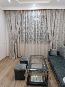 a living room with a couch and a table at Tevosyan EVN Airport in Pʼarakʼar