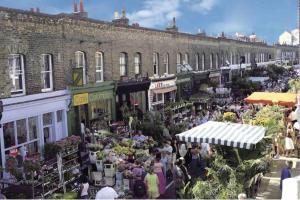 a crowd of people walking around an outdoor market at Modern apartment moments from Shoreditch in London