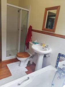 a bathroom with a toilet and a sink and a shower at Oppikrom Rivertide 36 in St Francis Bay