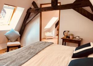 a bedroom with a bed and a mirror at L’AMANTINE Chambres d’hôtes et gîte in Bourges