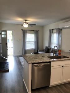 a kitchen with a sink and a counter top at Lakewoodlyon Park Renovated Cottage Near Duke 23a in Durham