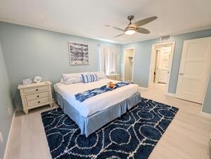 a bedroom with a bed and a ceiling fan at Sea Club Condo #405 in Clearwater Beach