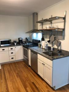 a kitchen with a sink and a counter top at Renovated Space Close To Downtown - A in Durham