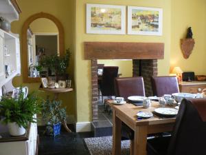 a dining room with a table and a fireplace at 16 Franklin Bijou Boutique in Harrogate