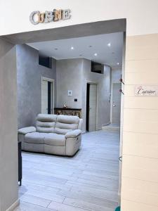 a living room with a couch and a table at Lady Luxury Apartment in Bari