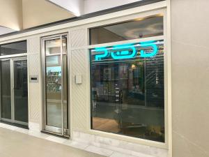 a store window with a blue neon sign on it at The POD Suite Hostel in Valencia