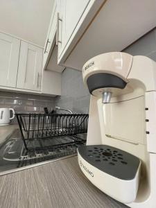 a white mixer sitting on the counter in a kitchen at Studio in Reading 