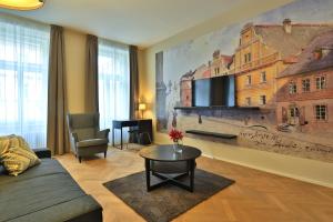 a living room with a large painting on the wall at James Hotel & Apartments in Prague