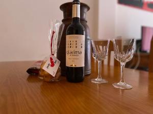 ベナスケにあるLH Casa Chispaのワイン1本とワイングラス2杯(テーブル上)