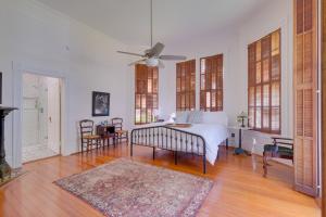 a white bedroom with a bed and a ceiling fan at WFH Friendly Abode with Balcony in Columbus! in Columbus