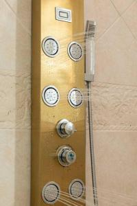 a shower door with clocks on it in a bathroom at Paradise Retreat, A Tropical Oceanfront Villa in Freeport