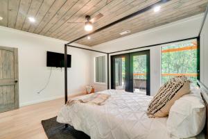 a bedroom with a large bed and a tv at Luxe Sevierville Home with Deck Near Pigeon Forge! in Sevierville