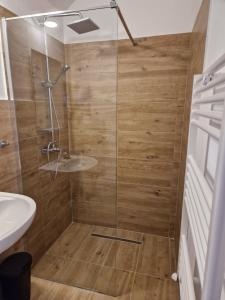 a shower with a glass door in a bathroom at Casa 7 SATE apartament in Săcele +20 photos