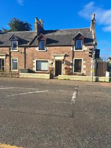 a brick house on the side of a street at No 27 in Inverness