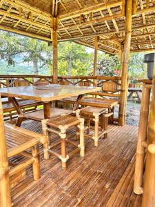 a large wooden table and benches on a deck at Appartement à la ferme in Thoard