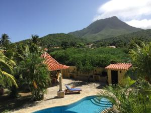 a resort with a pool and mountains in the background at Villa Cocuyo Studios in El Cardón