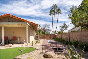a backyard with a retaining wall and a fence at The Rusty Cactus in Phoenix