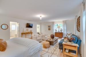a bedroom with a bed and a living room at Idyllic Cave Spring Studio with Patio and Fire Pit! in Cave Spring